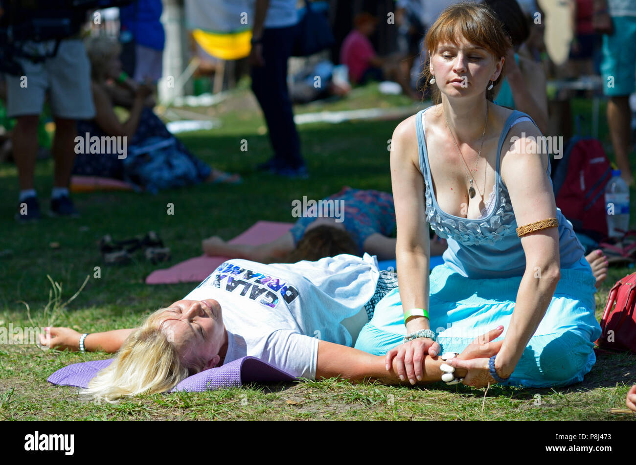 People practicing Thai massage during festival of Yoga and Vedic Culture  “Vedalife-2017, Island”. August 7, 2017. Kiev, Ukraine Stock Photo - Alamy