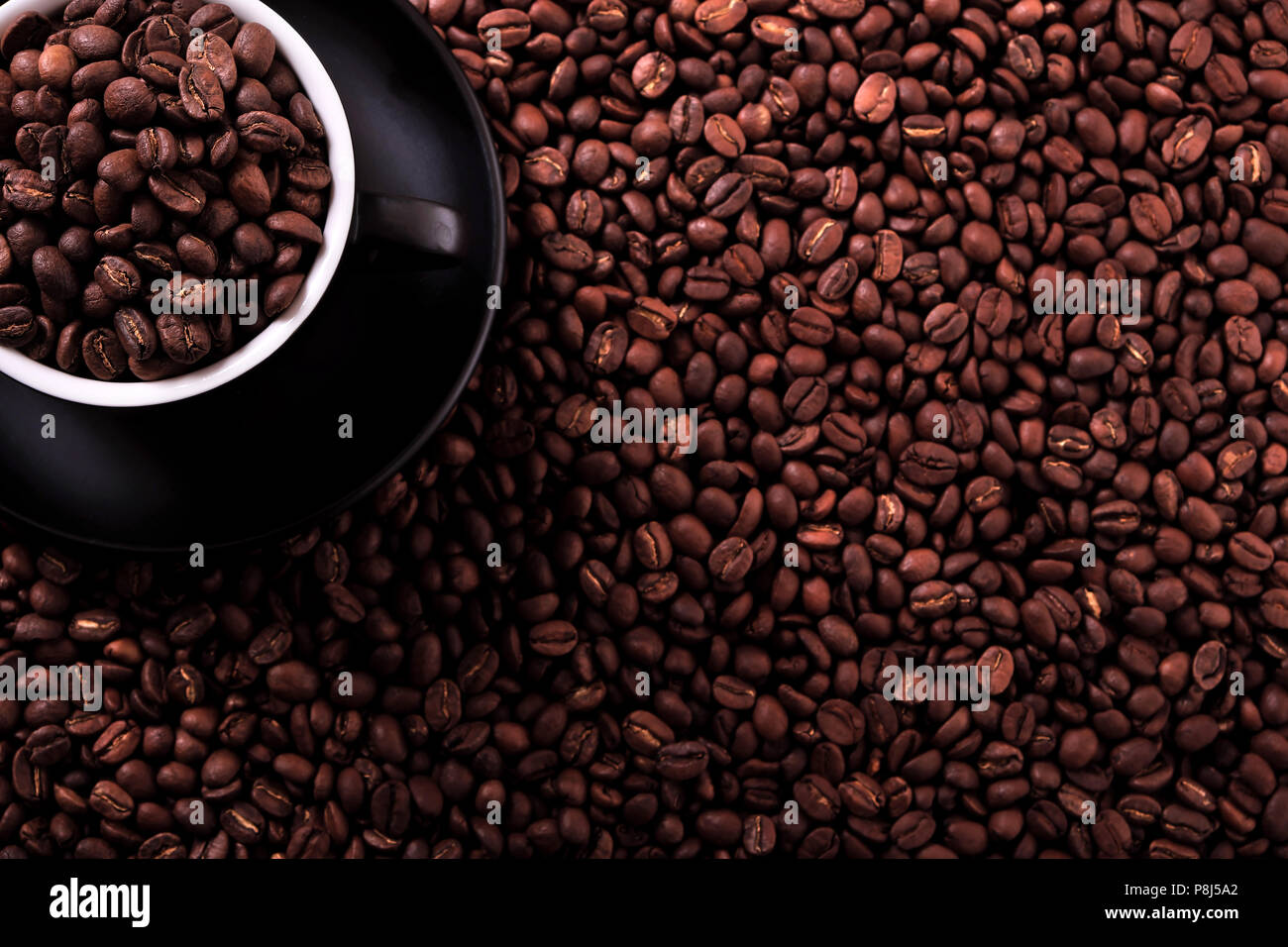 Black coffee cup with roasted beans background Stock Photo