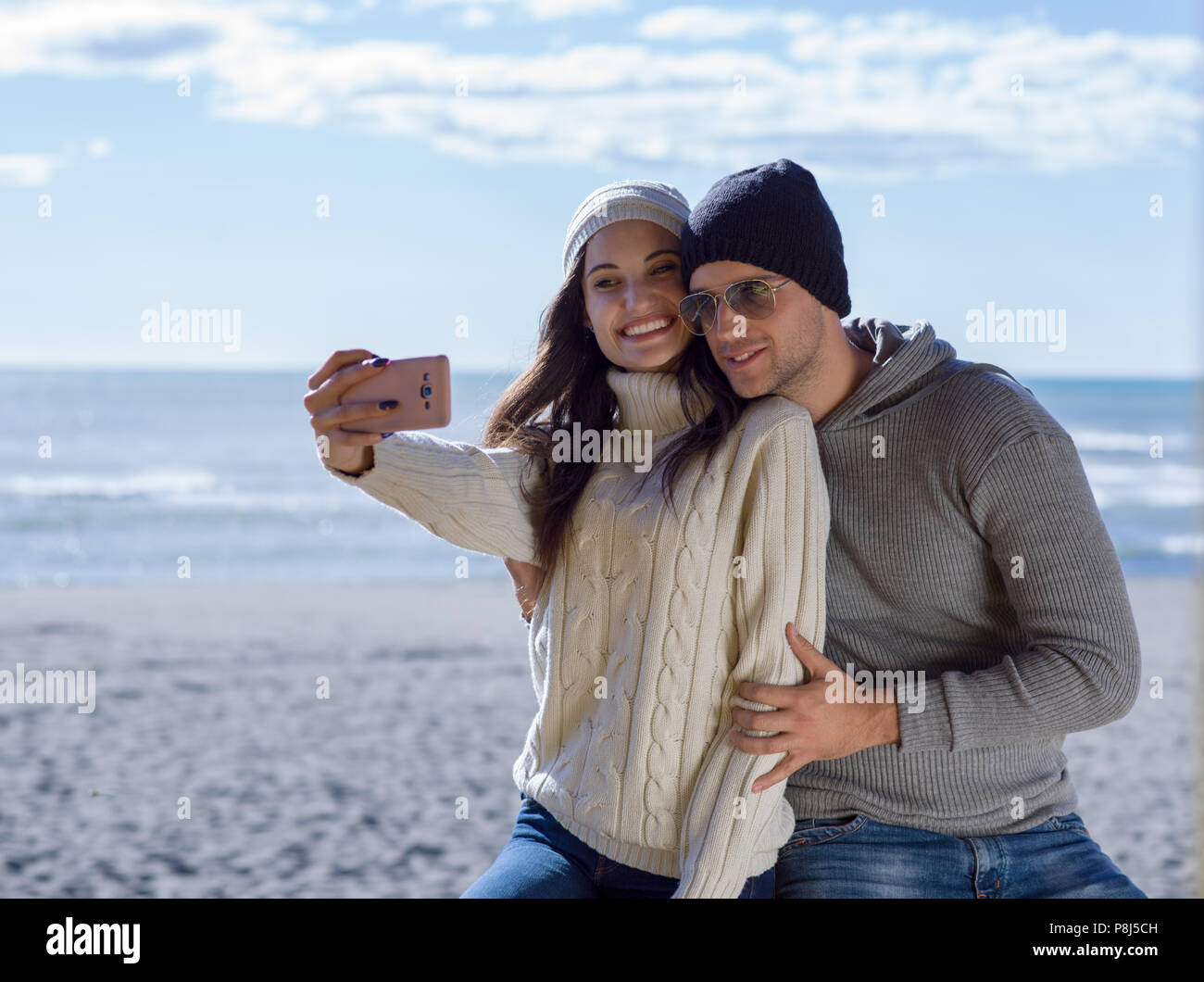 Very Happy Couple In Love Taking Selfie On The Beach in autmun day ...