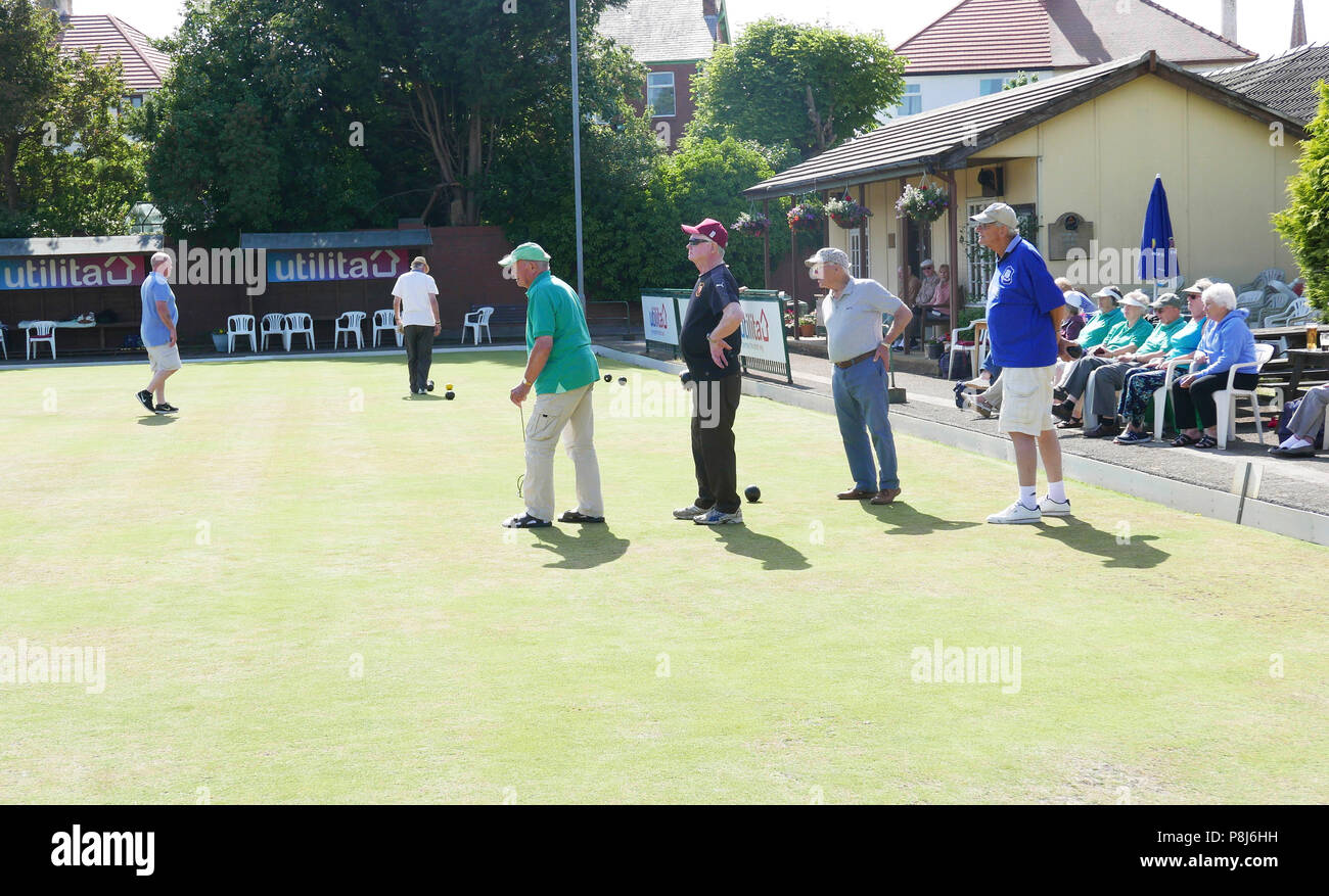 Group of senior men line up to bowl on the Raikes Hotel,crown green bowling green,Blackpool,Lancashire,UK Stock Photo