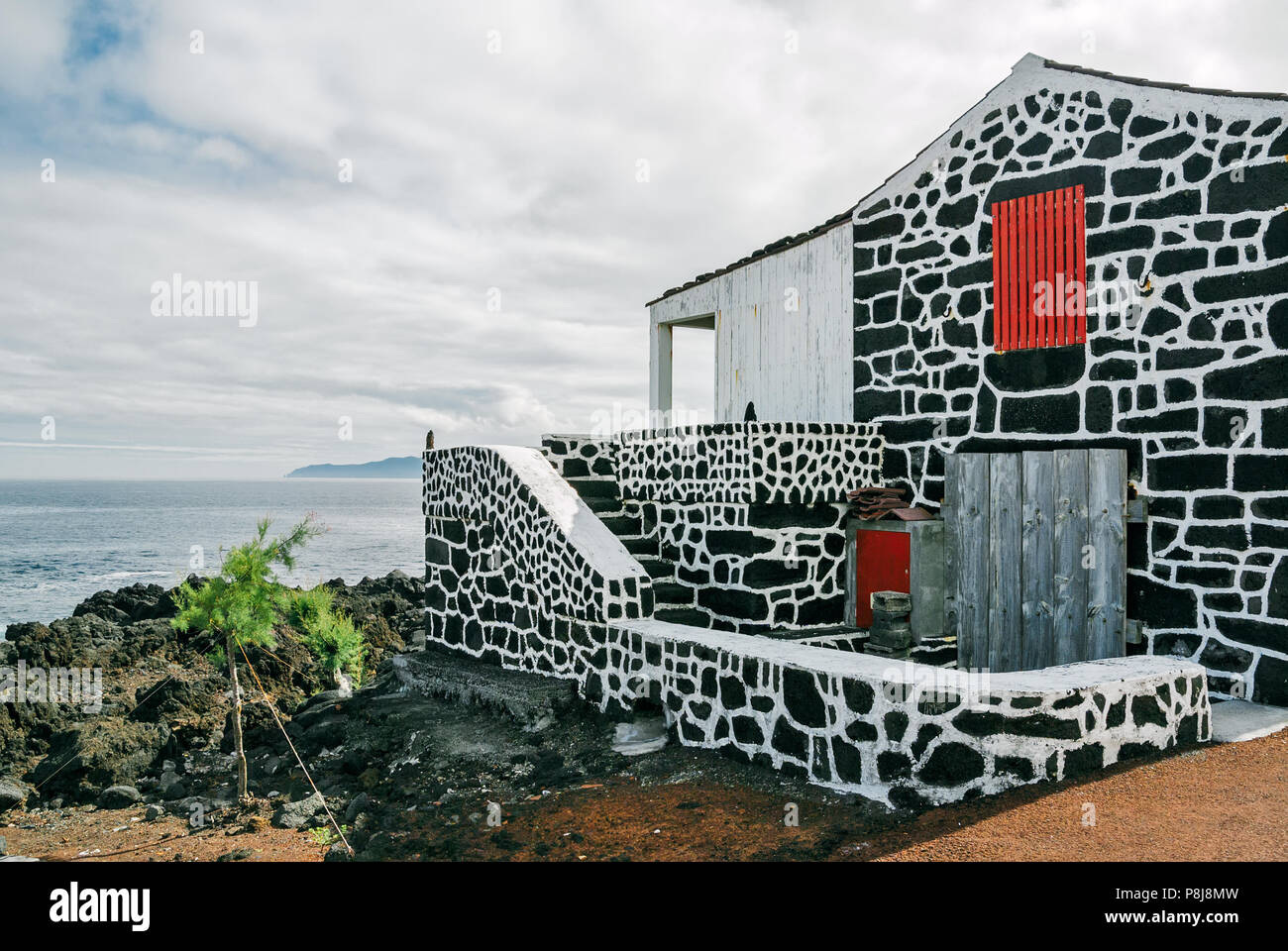 A traditional house made with dark volcanic rocks at a village on Pico Island, Azores, Portugal. Stock Photo