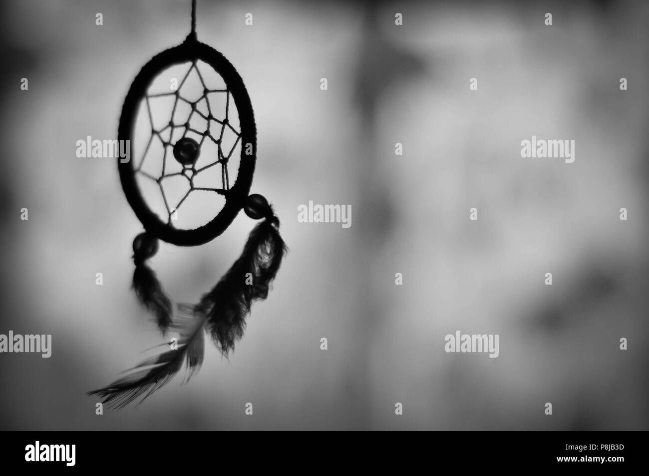 handmade dreamcatcher black and white, blurred background Stock Photo