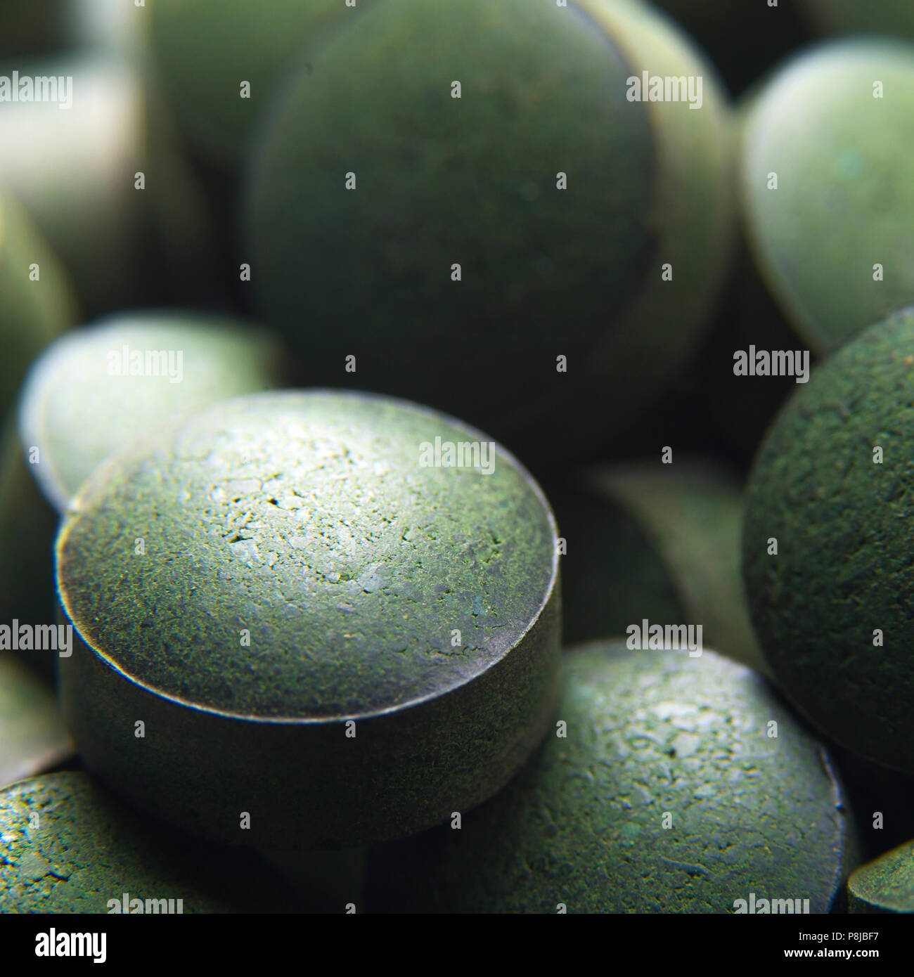 Blue green algae. Close up of natural organic spirulina tablets with