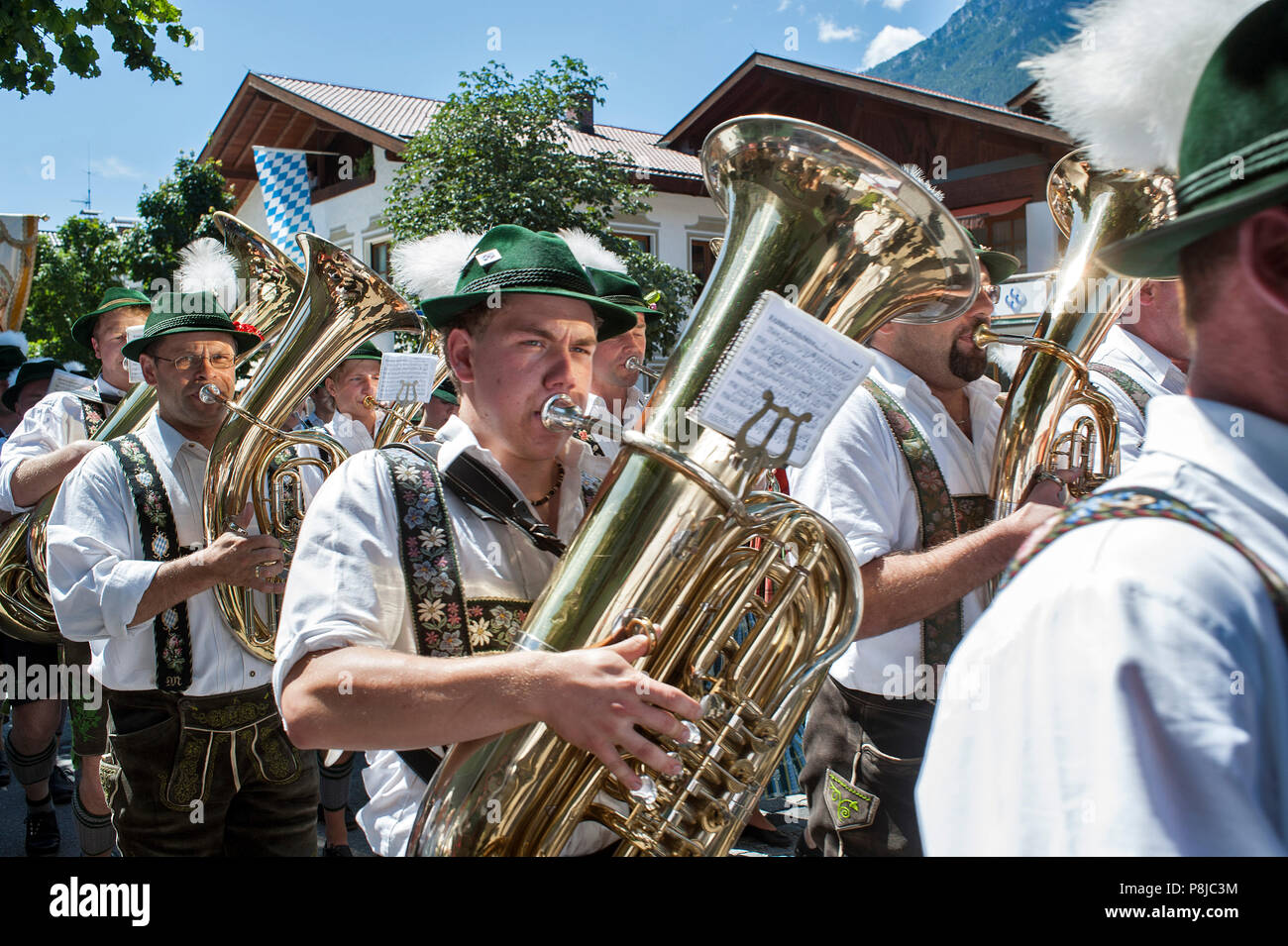 Procession of a Bavarian brass band in the city of Garmisch-Partenkirchen. Stock Photo