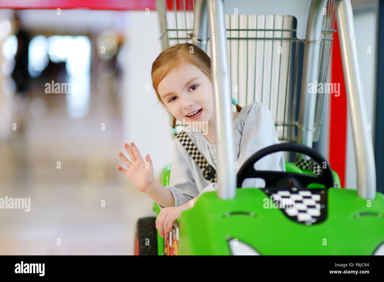Adorable little girl sitting in shopping cart Stock Photo - Alamy