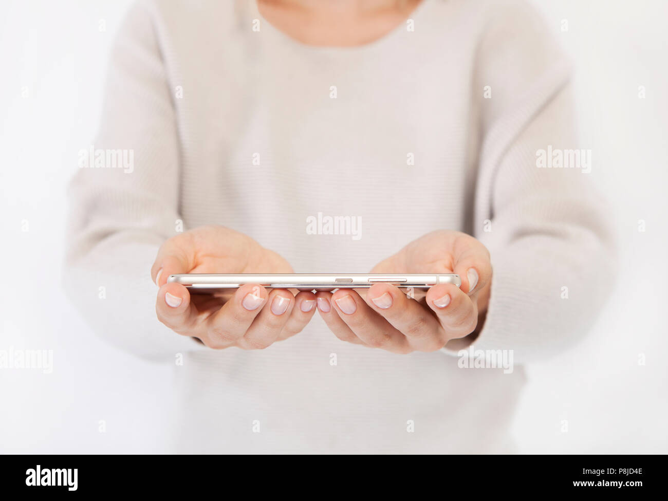 a woman holding a modern phone in her hands, no face Stock Photo