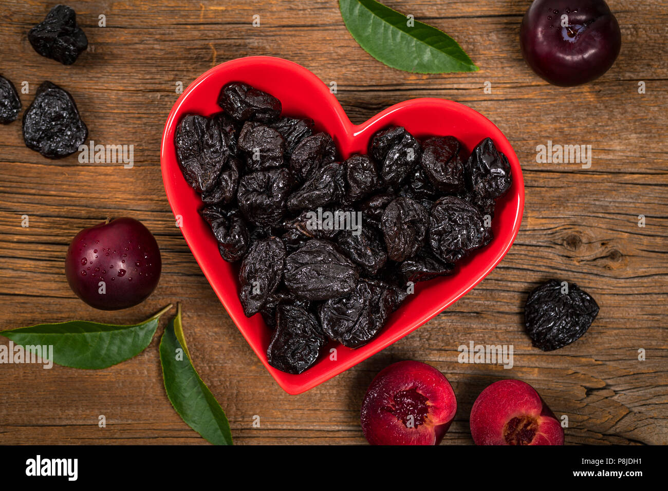 Dried Plums Pitted Prunes in Heart Shaped Bowl Background Stock Photo