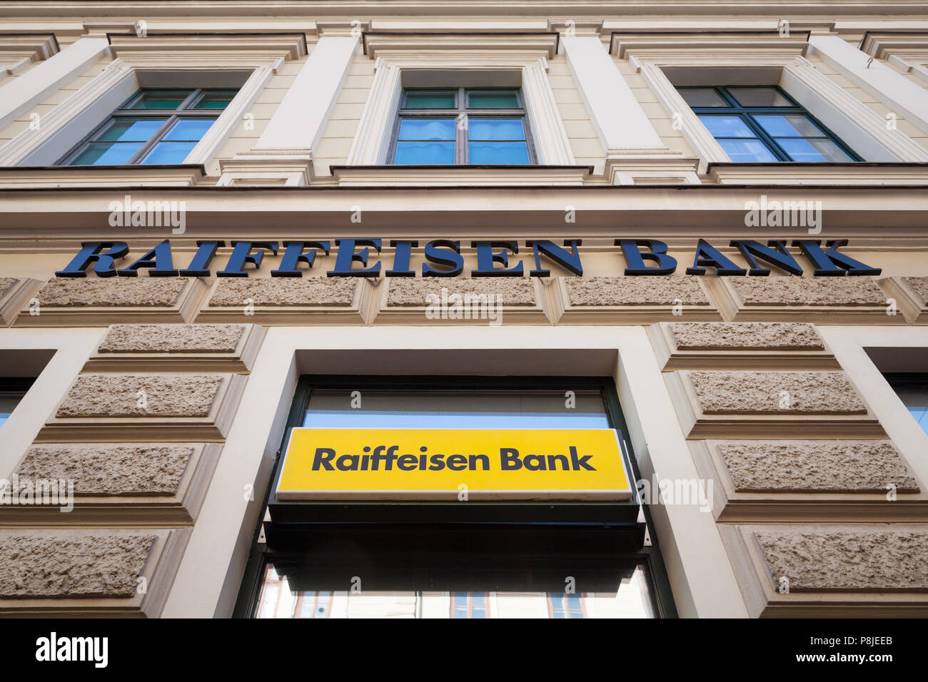 SZEGED, HUNGARY, JULY 3, 2018: Raiffeisen logo on their main bank in the center of Szeged. Raiffeisen is an Austrian bank, massively investing in Cent Stock Photo