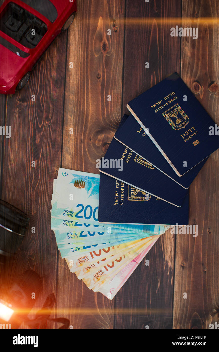 Stack of israeli money bills of 200 shekel and israeli passport. Stock Photo