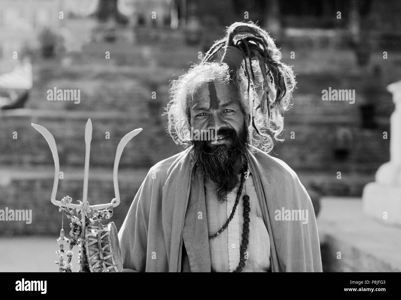 A SHAIVITE SADHU, Hindu follower of Shiva, with trident - KATHAMANDU, NEPAL Stock Photo