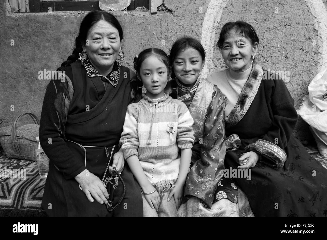 Khampa family at the Monlam Chenmo masked dances, Katok Dorjeden Monastery - Kham, (Tibet), Sichuan Province, China Stock Photo