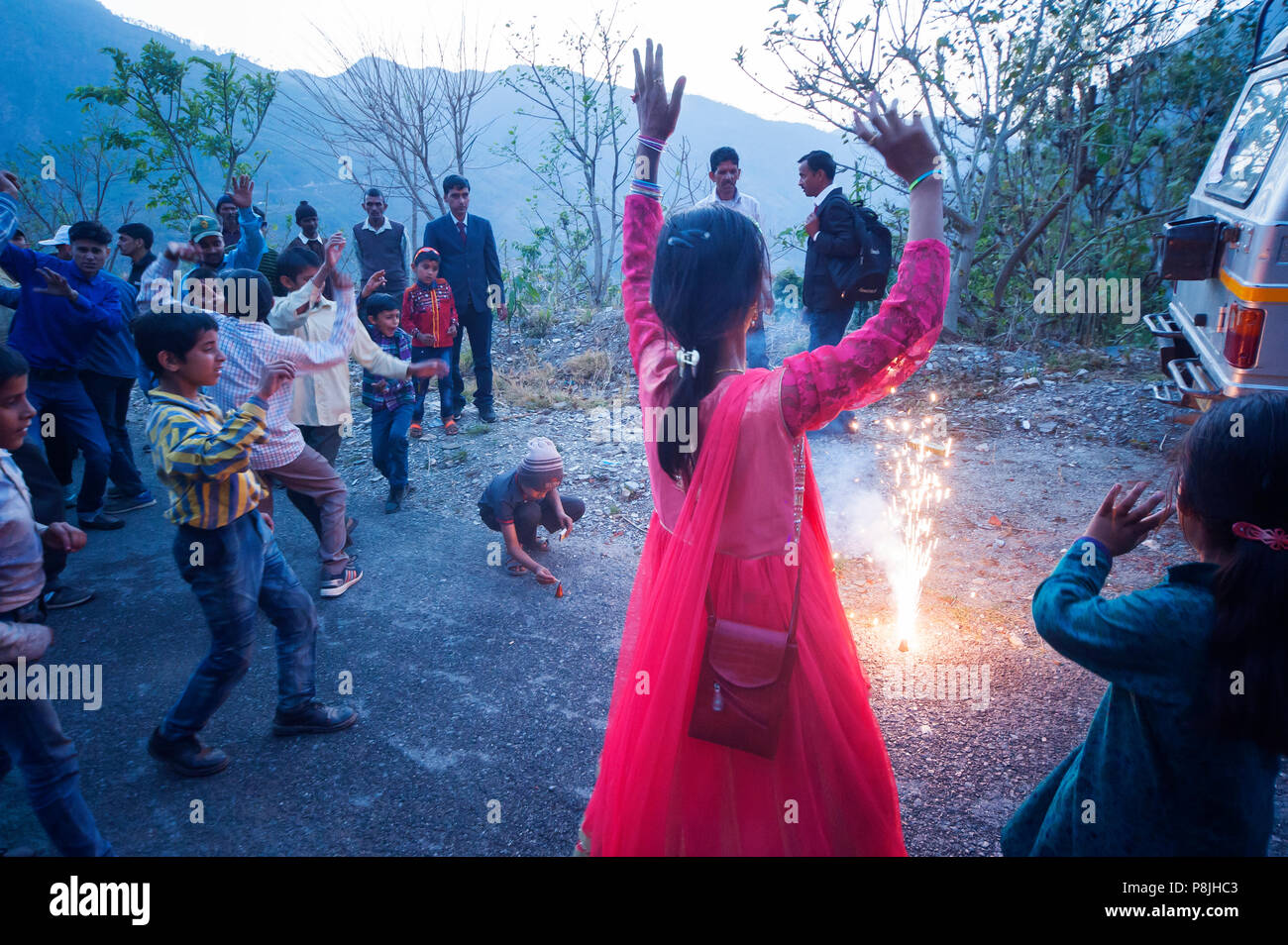 Indian people doing a happy wedding comemoration on the road at Adhora Village on the Nandhour Valley, Kumaon Hills, Uttarakhand, India Stock Photo