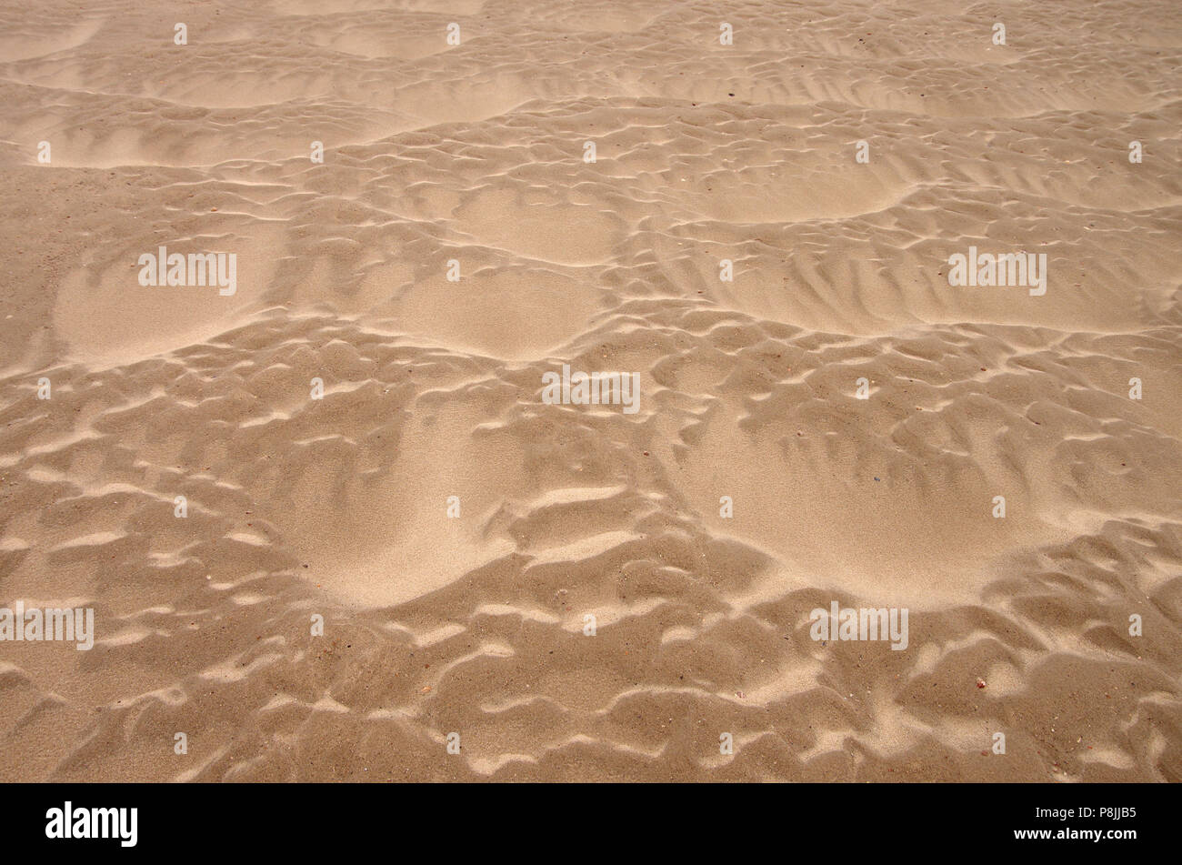 Sand patterns on the beach Stock Photo