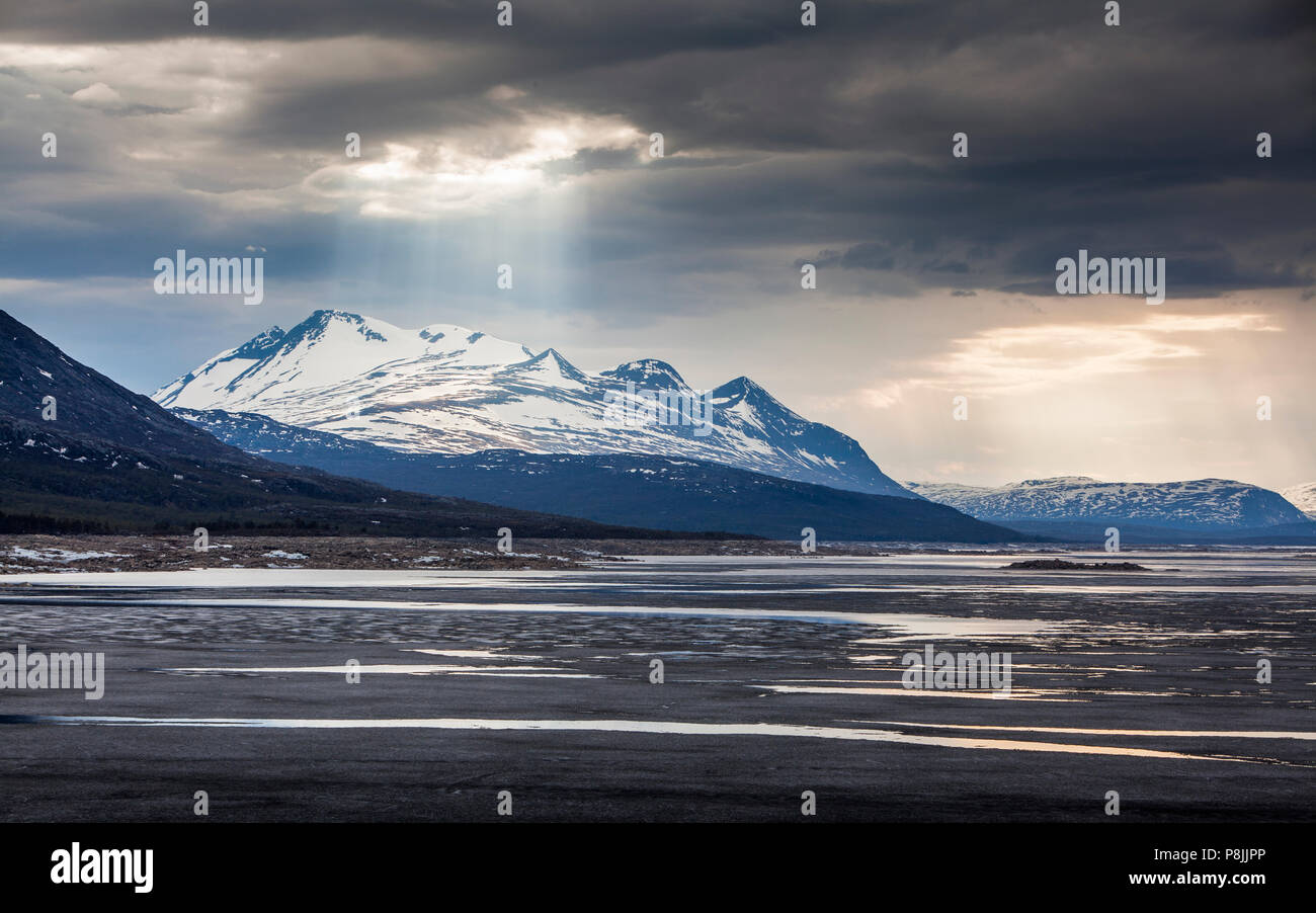 Landscape with the mountain range Akka and the halffrozen lake Akkajaure Stock Photo