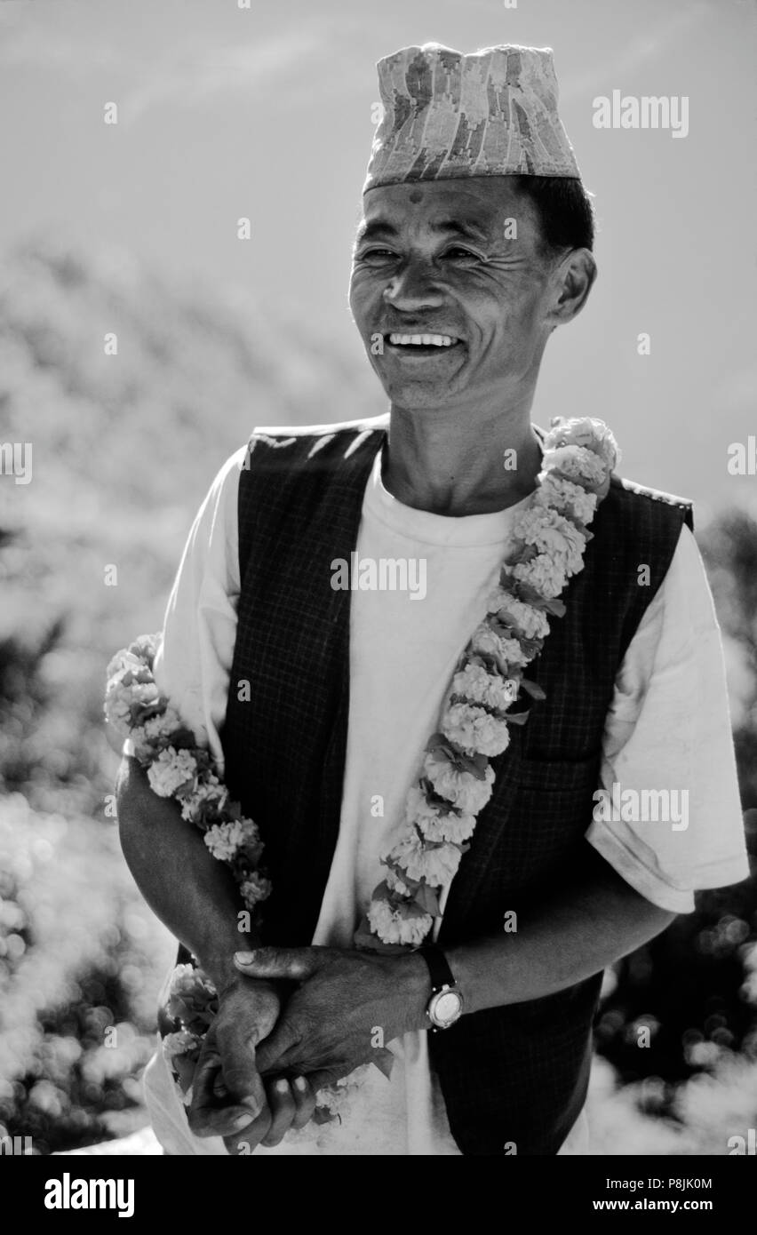 A RAI man celebrates BAI TIKA (BROTHER PUJA) during TIHAR on the return journey from MAKALU - NEPAL Stock Photo