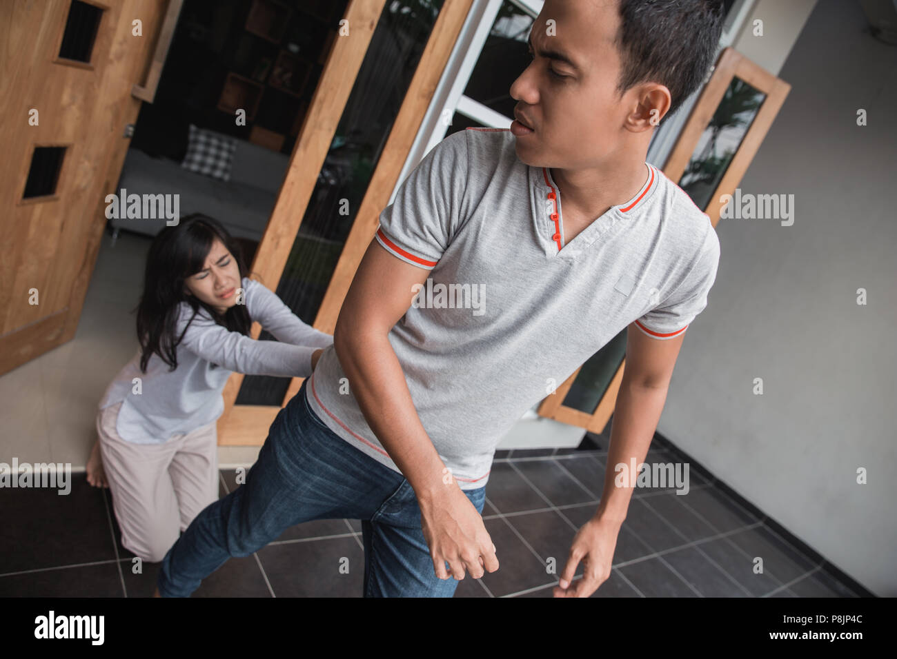 girl try to stop her boy friend to go during the fight. couple ...