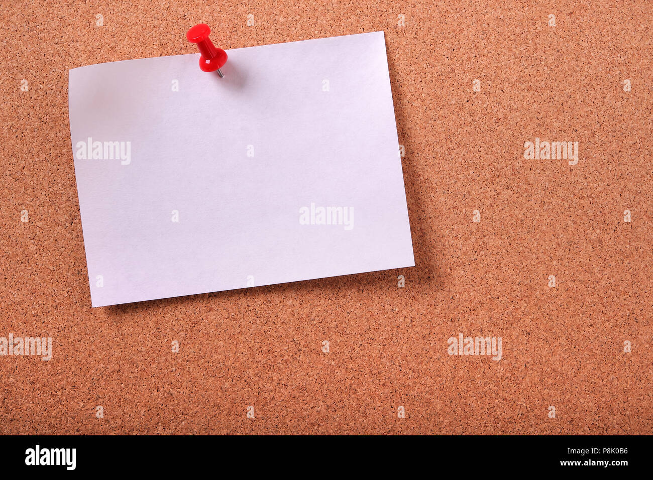 One white sticky post note pinned cork bulletin board Stock Photo