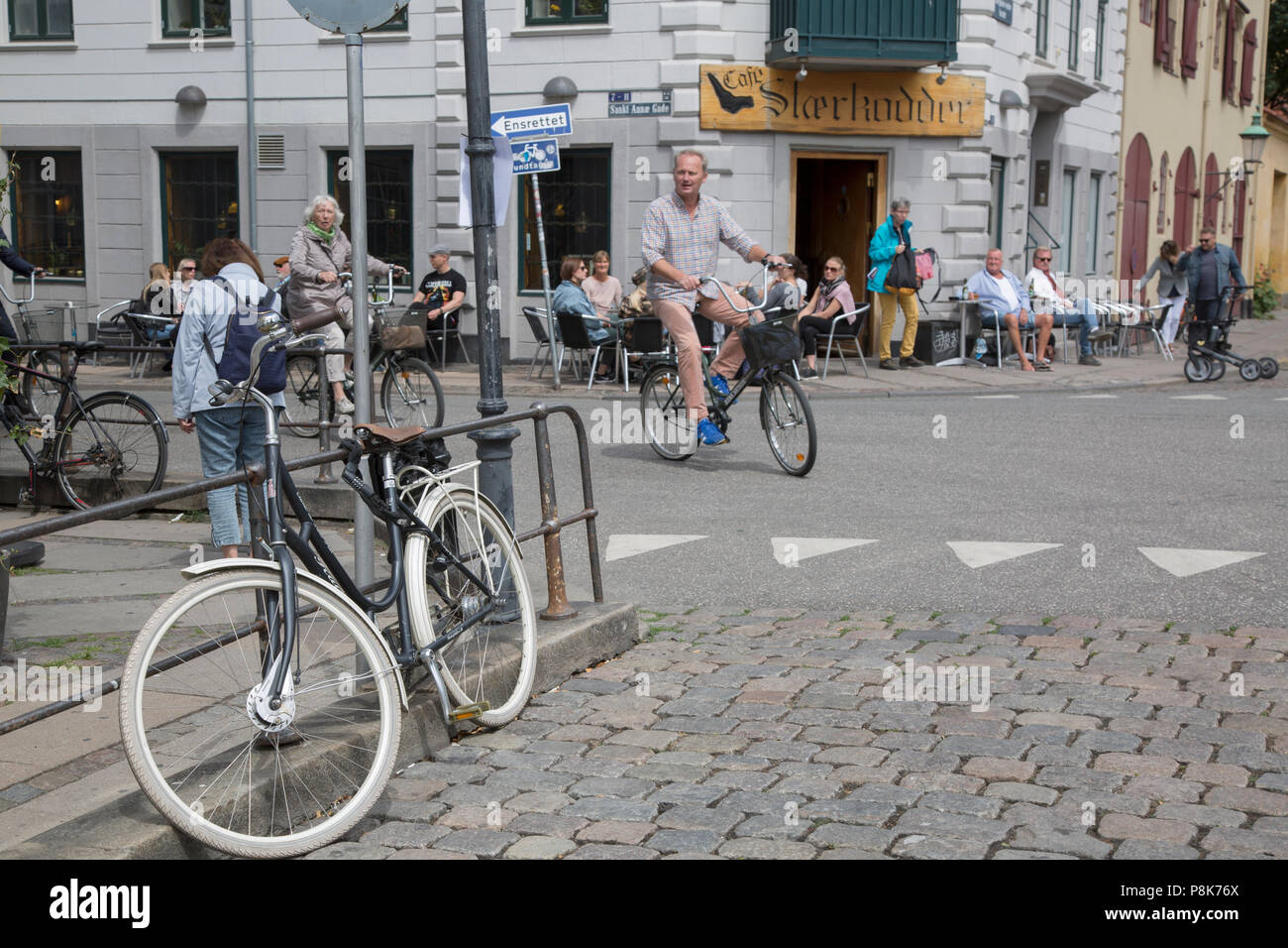 Man on Bike outside Cafe Staerkodder; Copenhagen; Denmark Stock Photo -