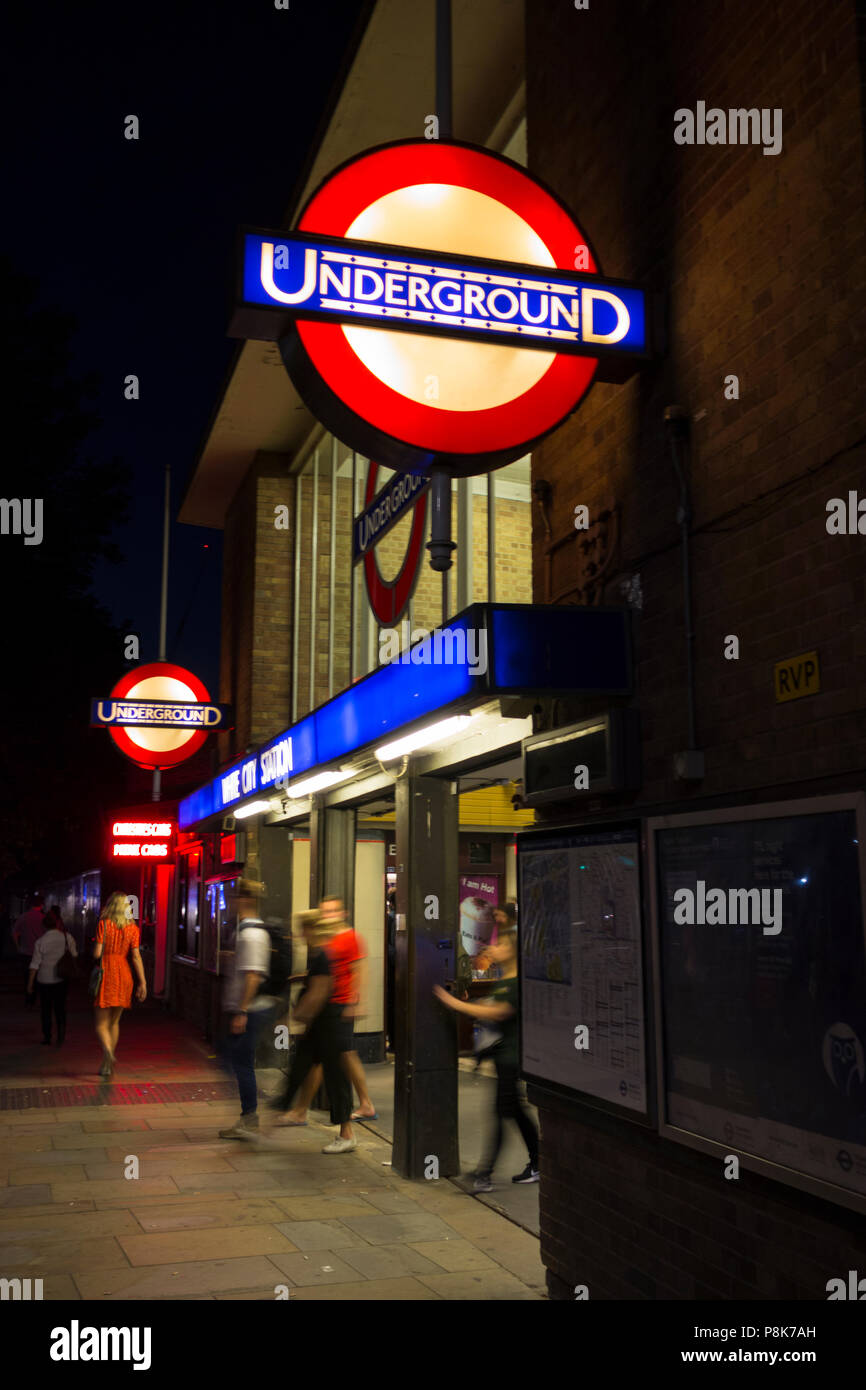 The entrance to White City underground station at night Stock Photo Alamy