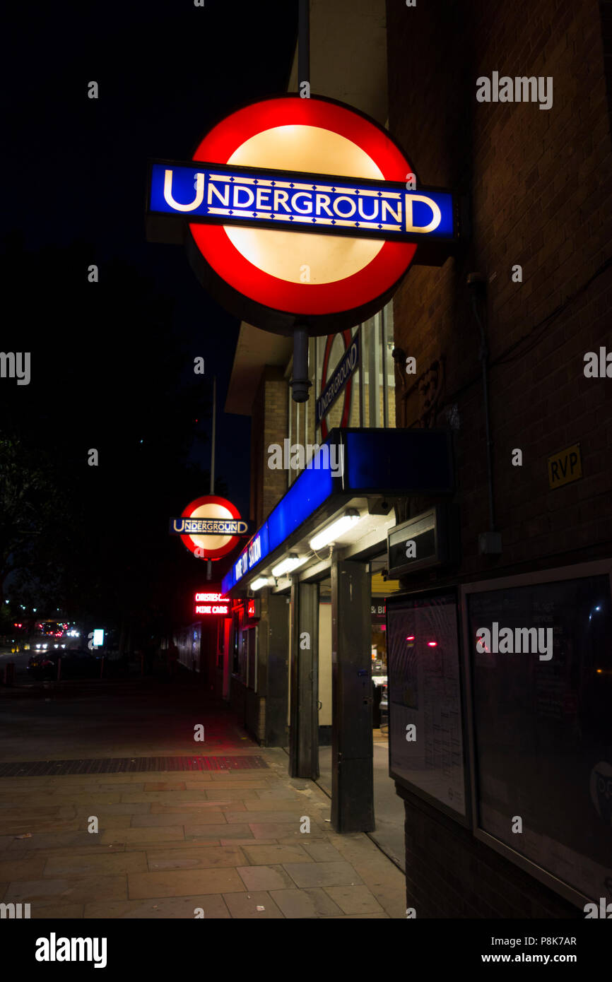 The entrance to White City underground station at night Stock Photo Alamy