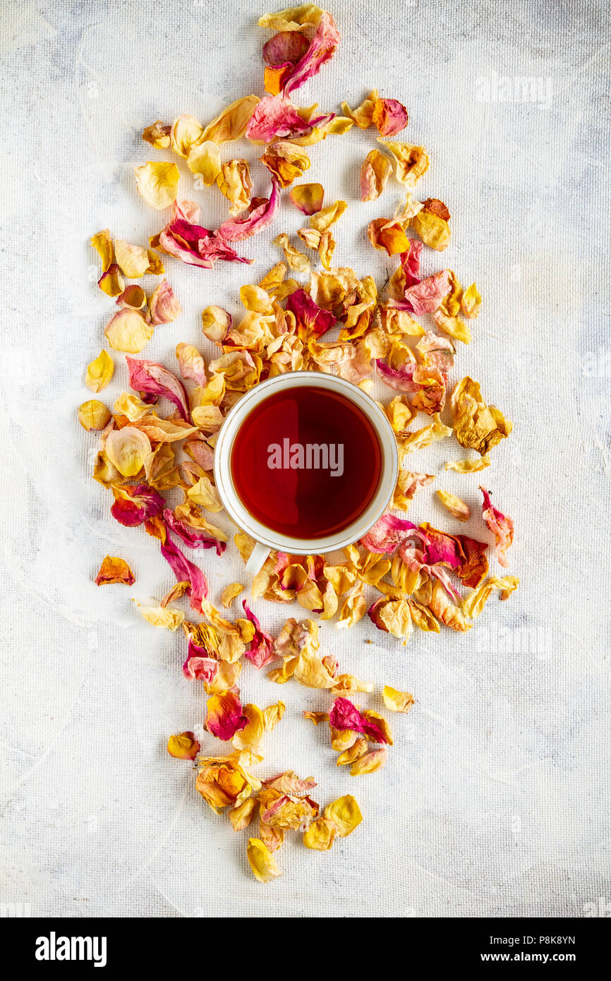Cup of tea and dried rose petal, flat lay shot Stock Photo