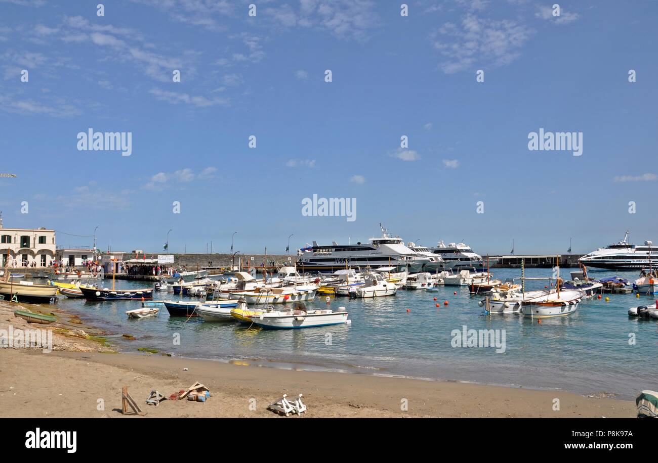 Landscape with a little harbor with beach and boats on the island and cloudy blue sky background. Saturated colors Stock Photo