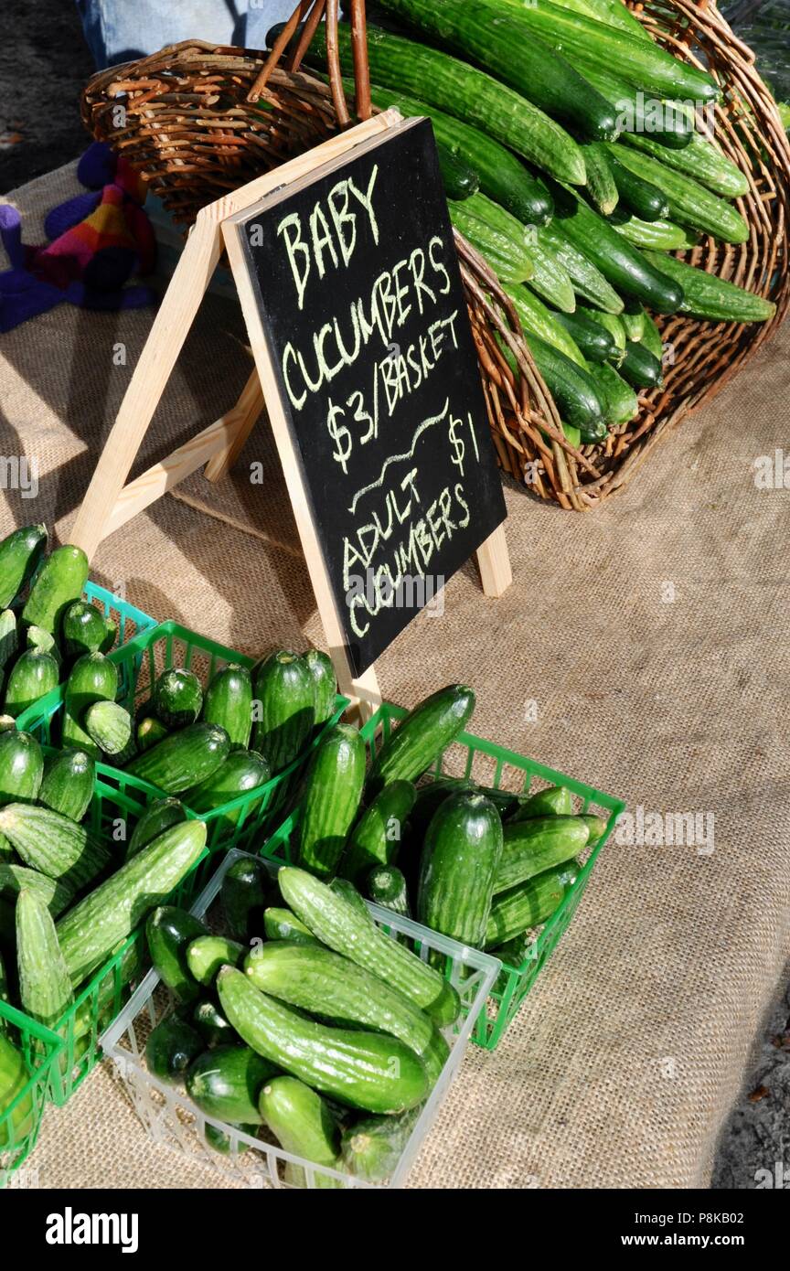 Funny "baby" and "adult" cucumbers displayed at farmers' market