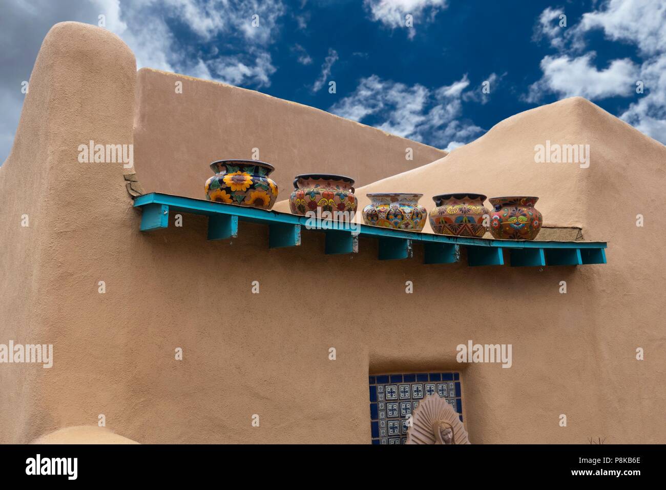 Southwest Adobe style building with handmade decorated Mexican ceramic pots, Taos, New Mexico Stock Photo