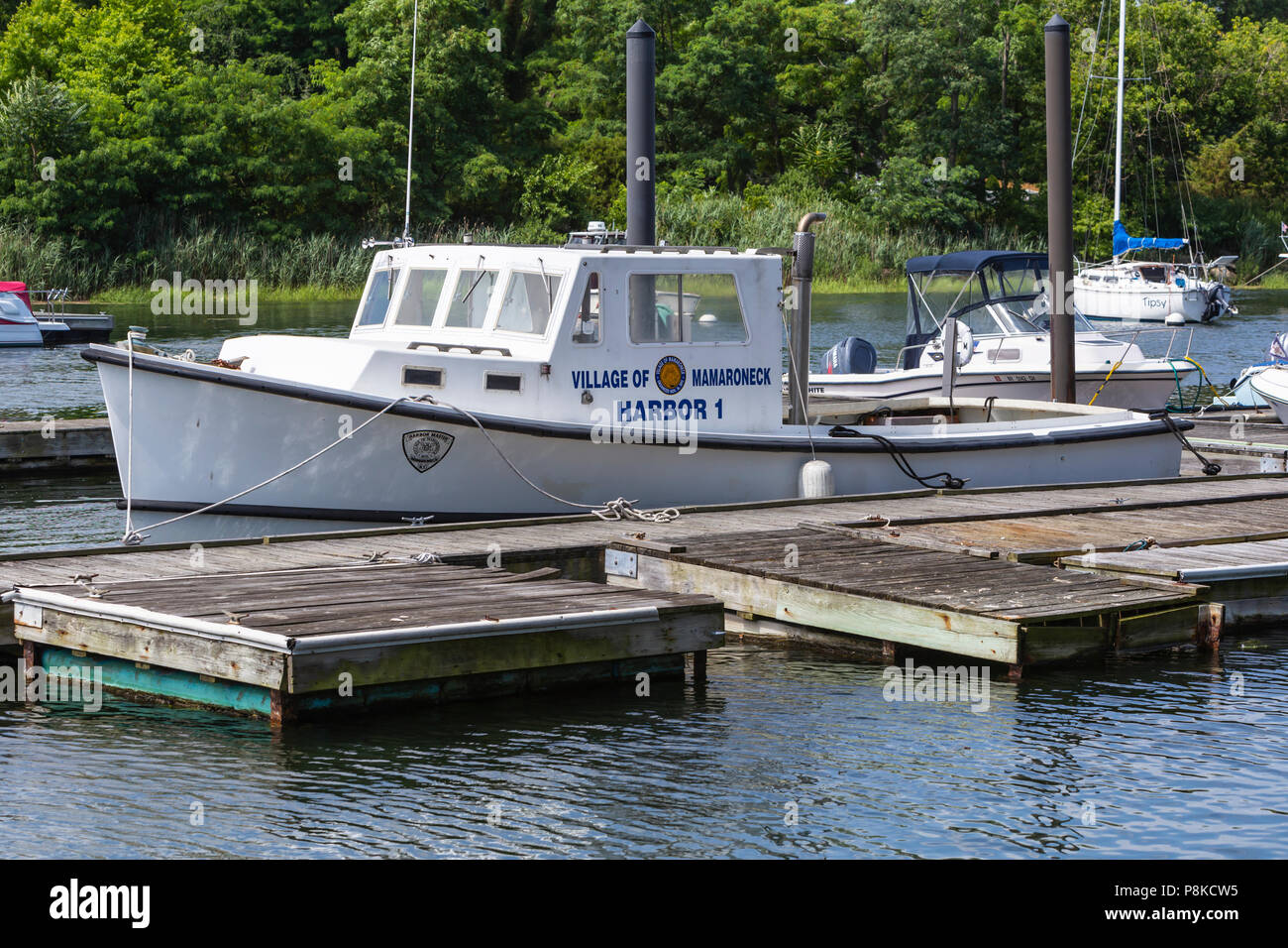 A Mamaroneck Harbor Master's boat docked in the West Basin of Mamaroneck Harbor in Harbor Island Park, Mamaroneck, New York. Stock Photo
