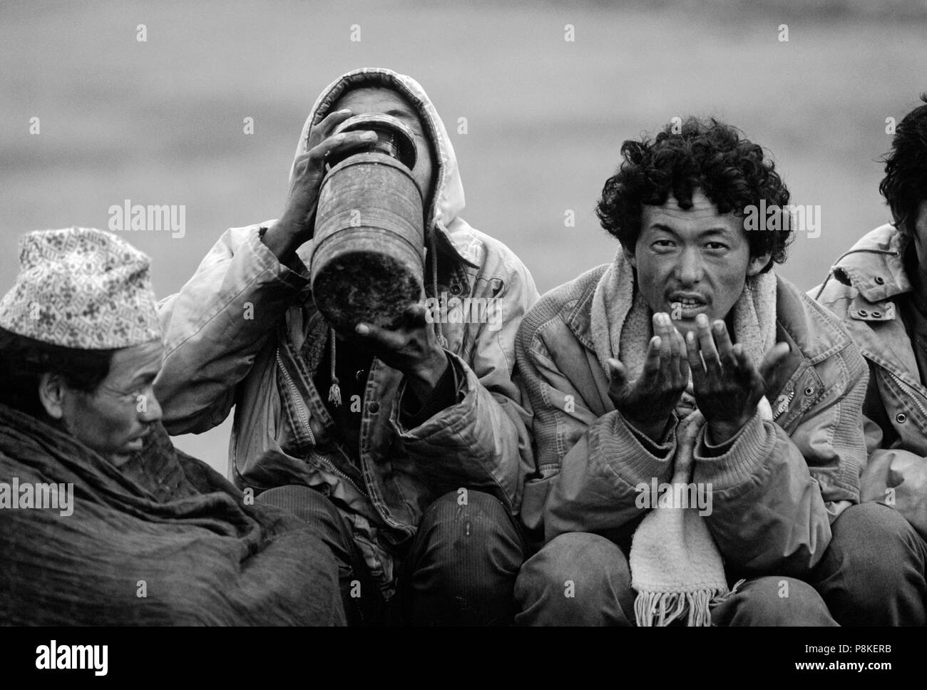 DOLPO MEN drink CHANG (liquor) during a Tibetan Buddhist FESTIVAL in the DO TARAP VALLEY - DOLPO, NEPAL Stock Photo