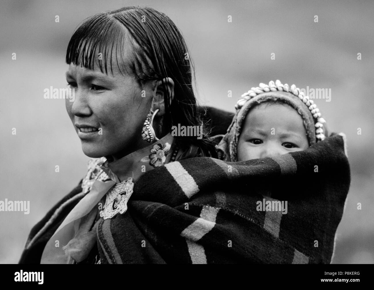 WOMAN and CHILD in DOLPO BLANKET and silver clasp at a Tibetan Buddhist FESTIVAL in DO TARAP VALLEY - DOLPO, NEPAL Stock Photo