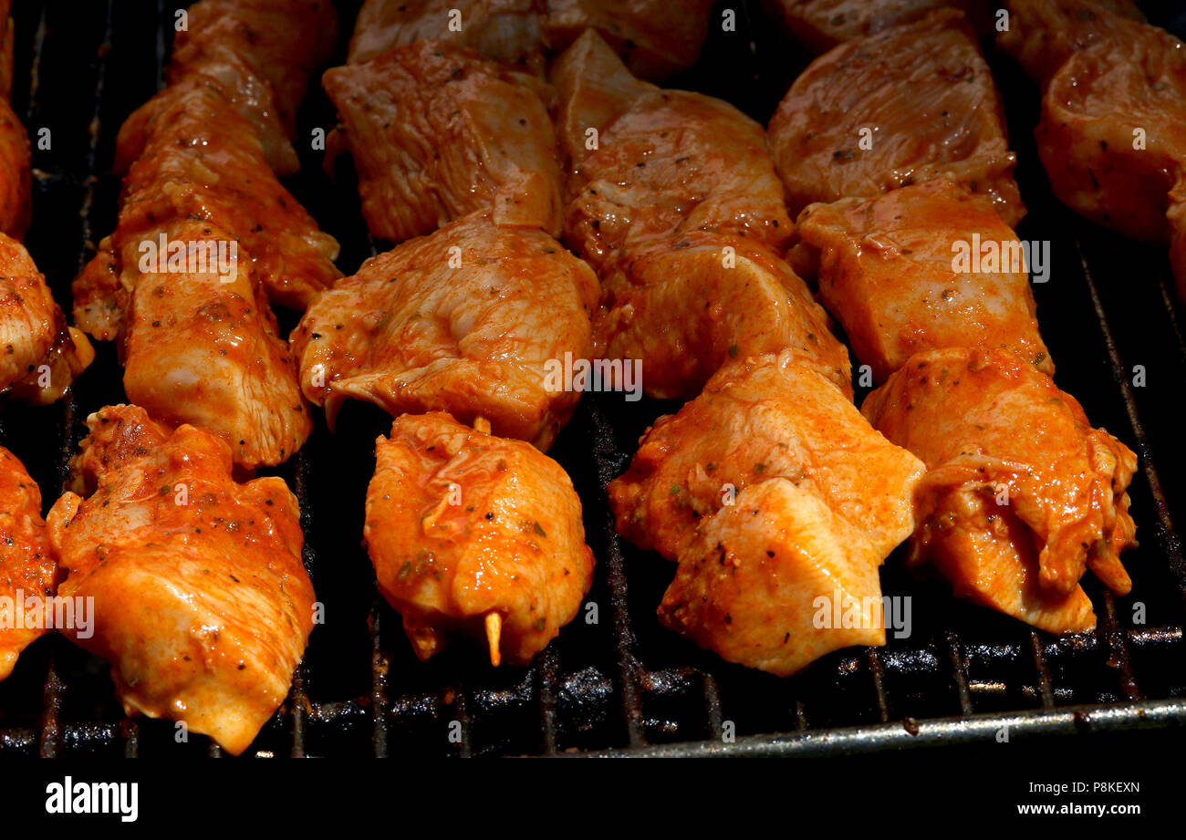 Chicken Kebabs cooking on a grill Stock Photo