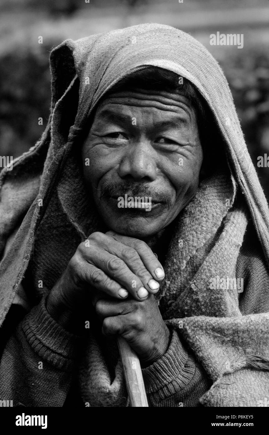 PORTRAIT of a GURUNG MAN with a blanket on his head - ANNAPURNA REGION, CENTRAL NEPAL Stock Photo