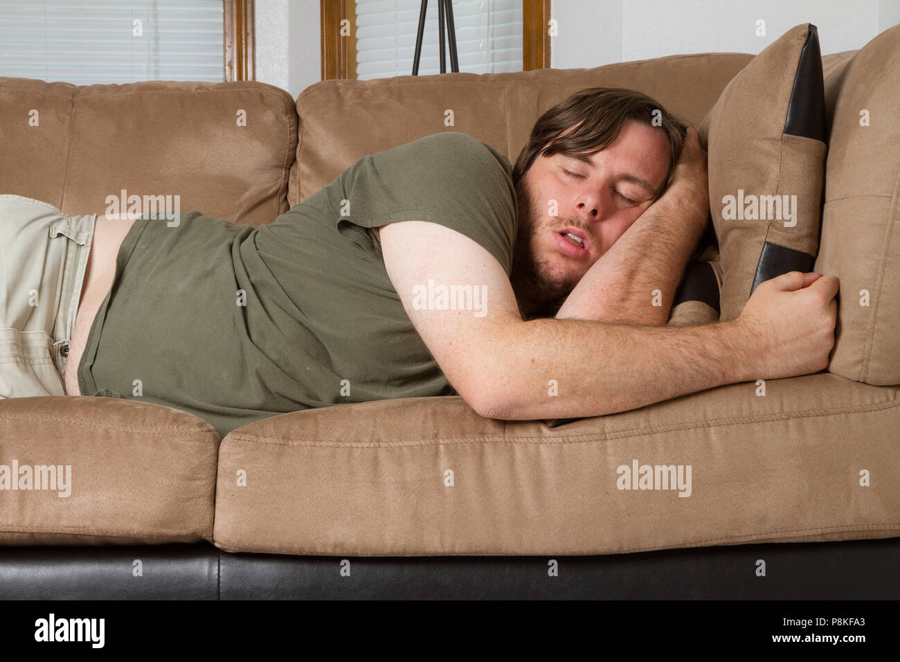 Asleep on the couch after a hard day. Stock Photo