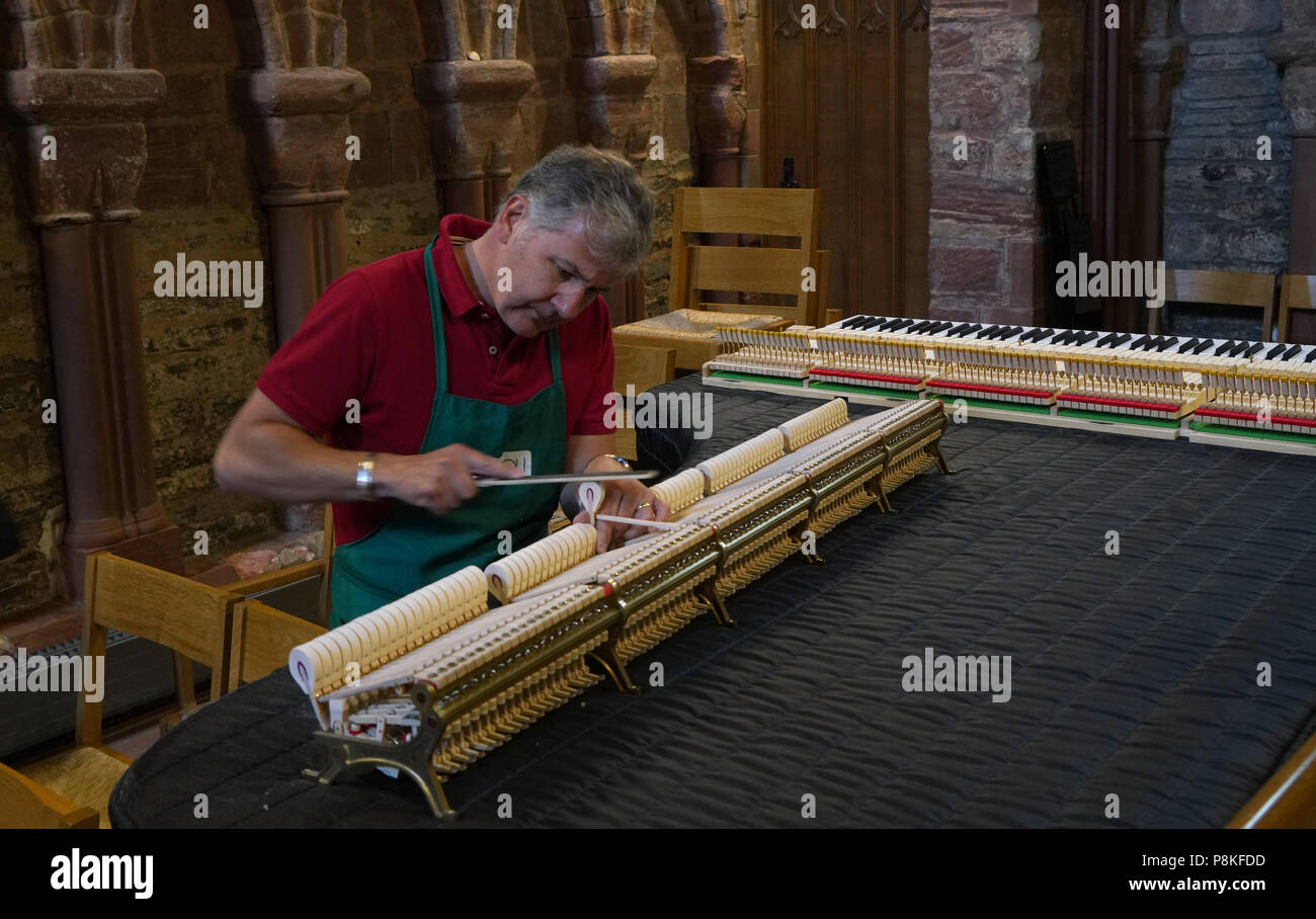 A piano tuner tunes a Steinway piano in the Magnus Cathedral in Kirkwall Scotland   Photo by Dennis Brack Stock Photo