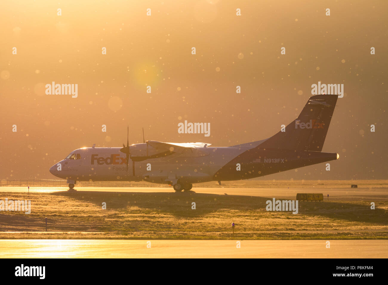 A FedEx Feeder aircraft is taxing out to deliver more packages. Stock Photo