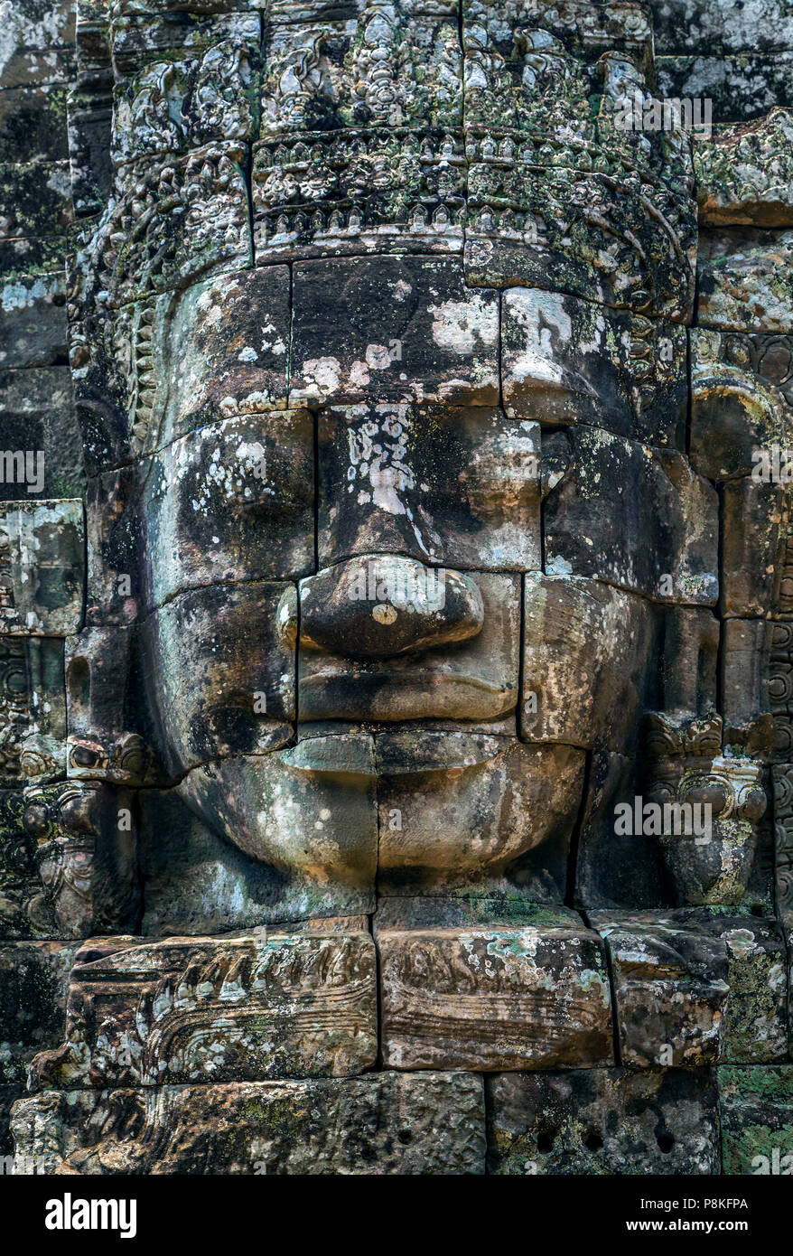 Stone face of Buddha on the tower of the ancient temple of Angkor Tom in Cambodia. Stock Photo