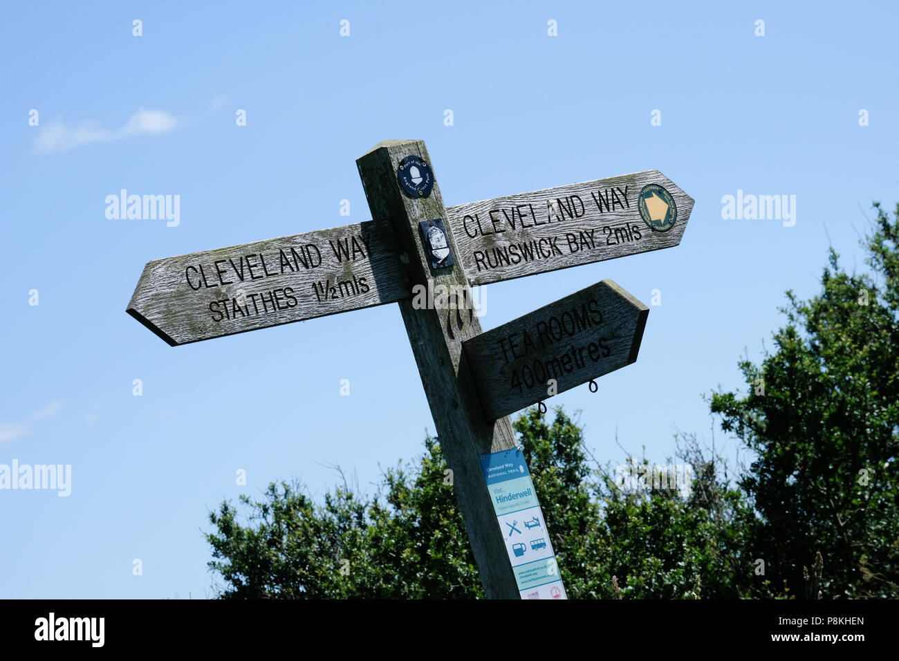 Sign post on the Cleveland Way above Port Mulgrave against blue sky and bushes Stock Photo