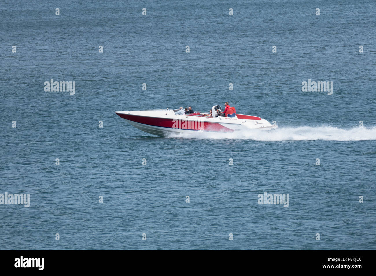 Speed boat travelling quickly across the sea with bough waves and ...