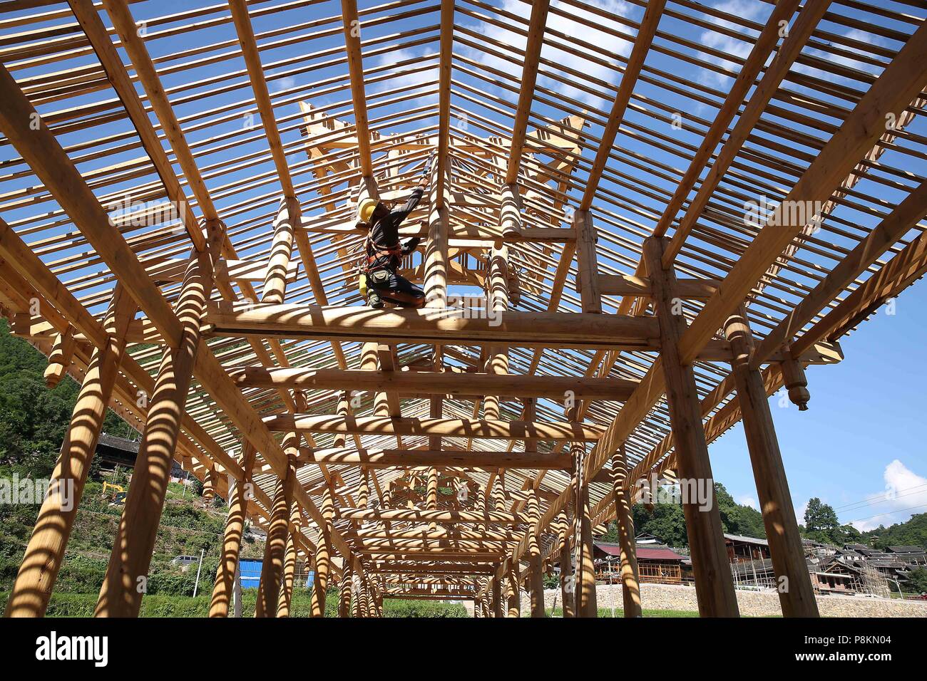 Danzhai, China's Guizhou Province. 11th July, 2018. A carpenter repairs