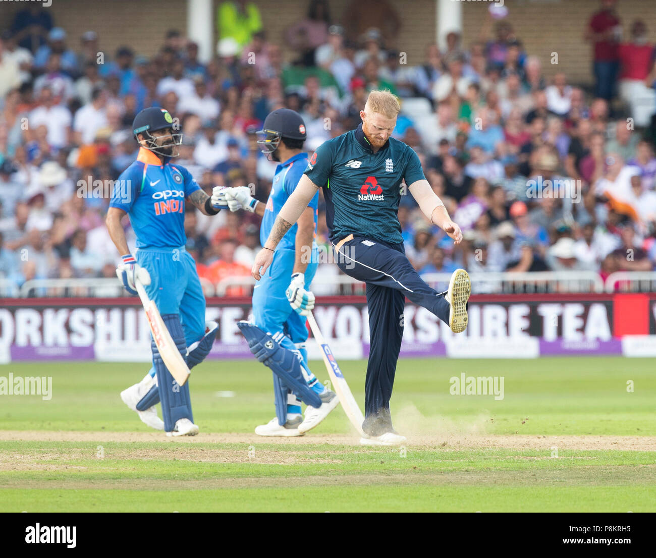 Nottingham, UK. 12th July 2018, Royal London, One Day International, England v India, Trent Bridge, Ben Stokes shows frustration as he concedes another boundary as Virat Kohli and Rohit Sharma celebrate in the background Credit: David Kissman/Alamy Live News Stock Photo