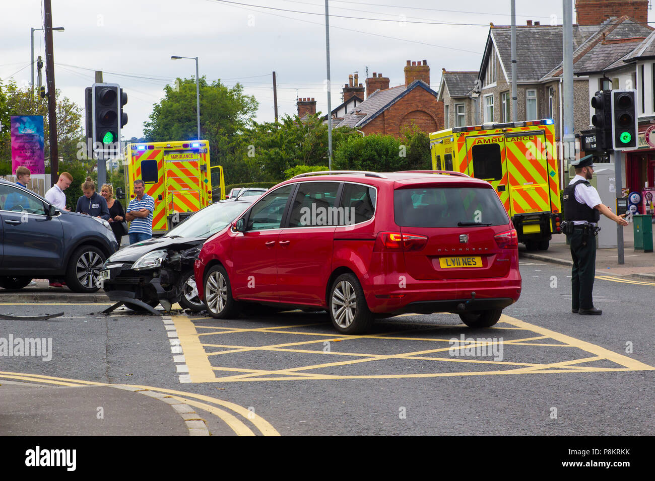Ballyholme, Northern Ireland. 12th July 2018. A multi vehicle road traffic accident at Ballyholme in Bangor County Ddown Northern Ireland with two ambulances in attendance. details of any injured persons are not yet available but the image shows extensive damge to vehichles with one having mounted the pavement at the entrance to the Windmill Road Credit: MHarp/Alamy Live News Stock Photo