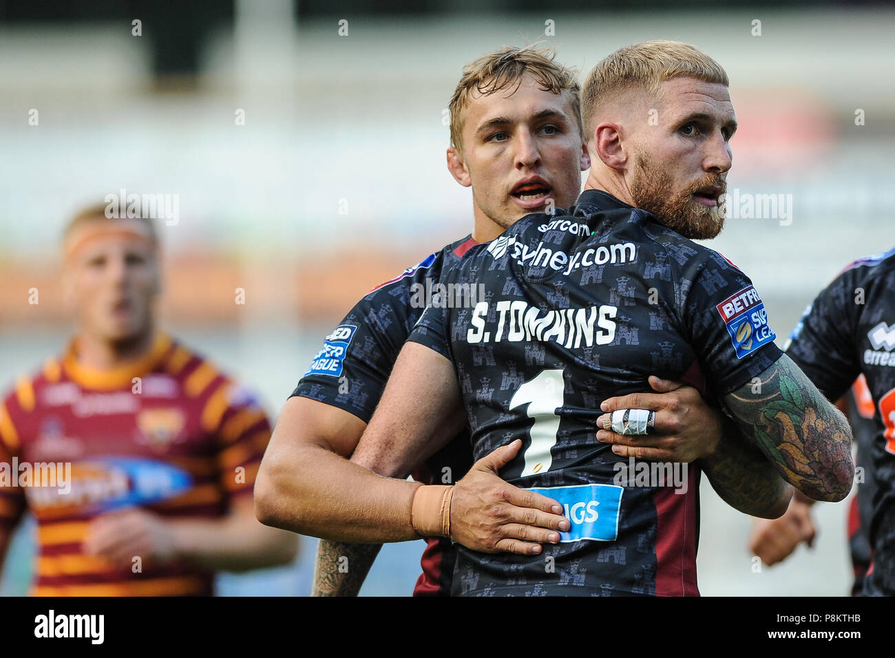 John Smiths Stadium, Huddersfield, UK. 12th July, 2018. Betfred Super League rugby, Huddersfield Giants vs Wigan Warriors; Wigan's Sam Powell congratulates team-mate Sam Tomkins on his opening try.  Dean Williams/Alamy Live News Stock Photo