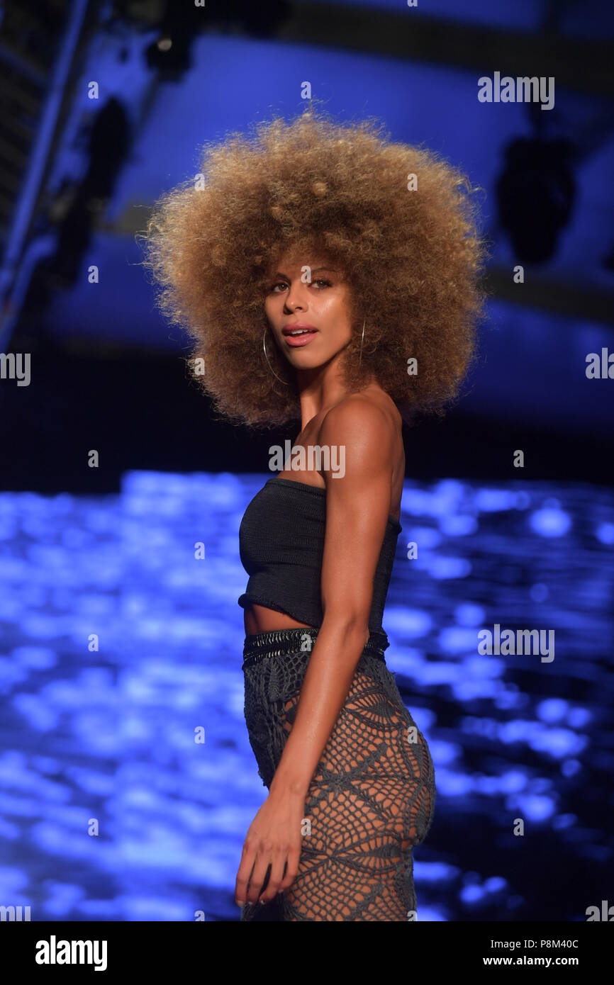 MIAMI BEACH, FL - JULY 12: Models back stage and walking the runway for