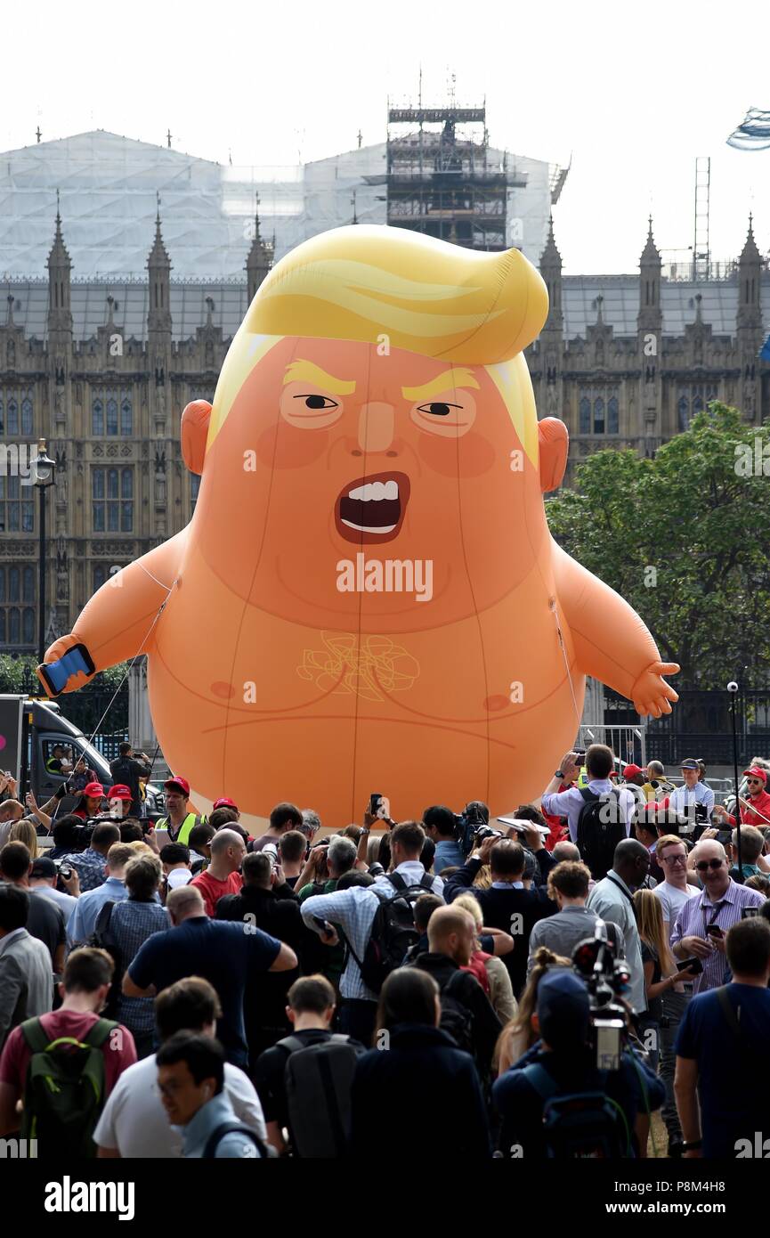 A six-metre balloon depicting as US President Donald Trump a nappy-clad orange baby over Parliament Square during the president's UK visit.  Credit: Finnbarr Webster/Alamy Live News Stock Photo