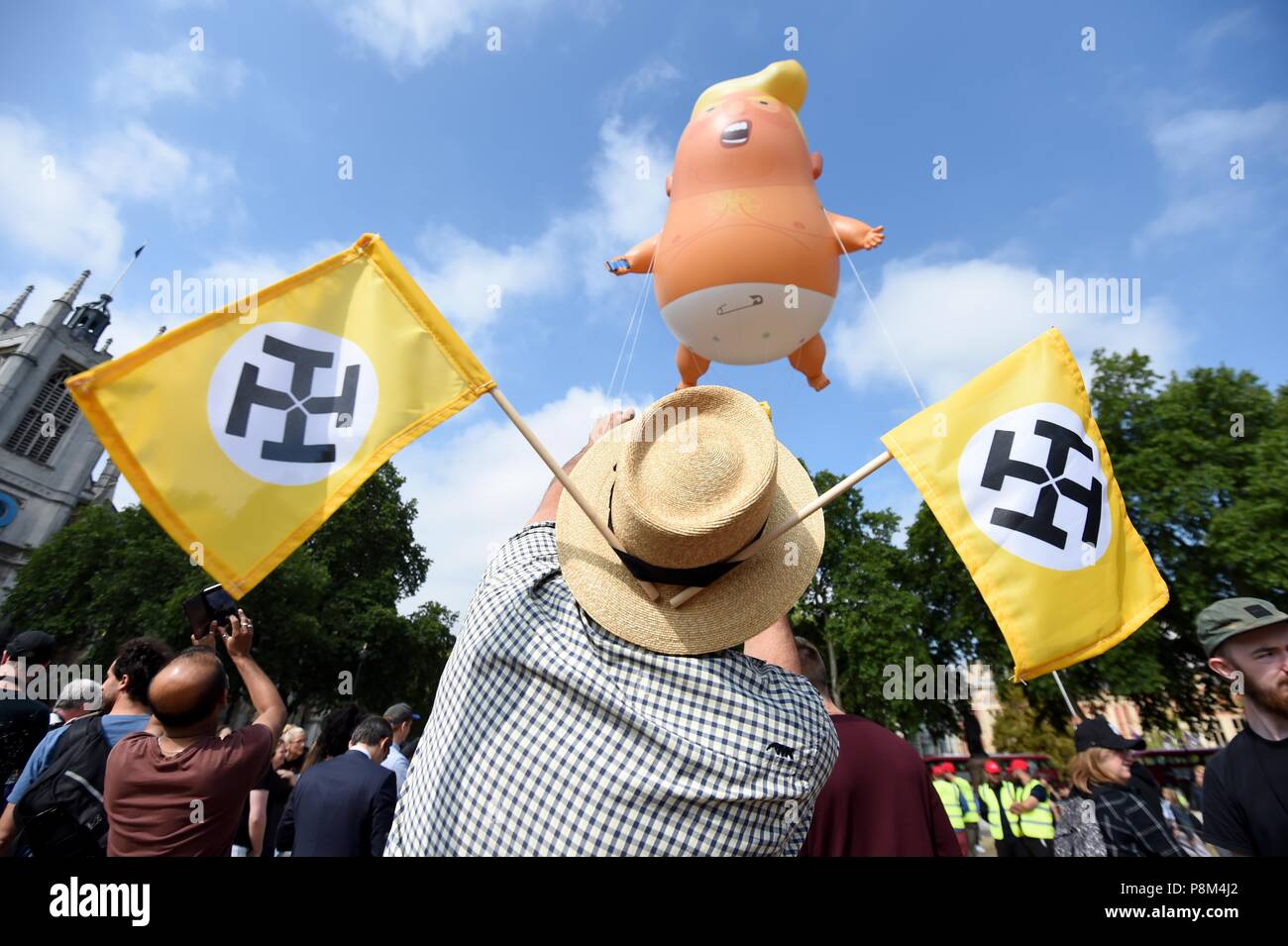 A six-metre balloon depicting as US President Donald Trump a nappy-clad orange baby over Parliament Square during the president's UK visit.  Credit: Finnbarr Webster/Alamy Live News Stock Photo