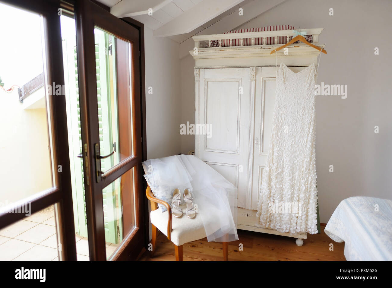 Beautiful Bride S Wedding Dress Hanging In An Adorable White