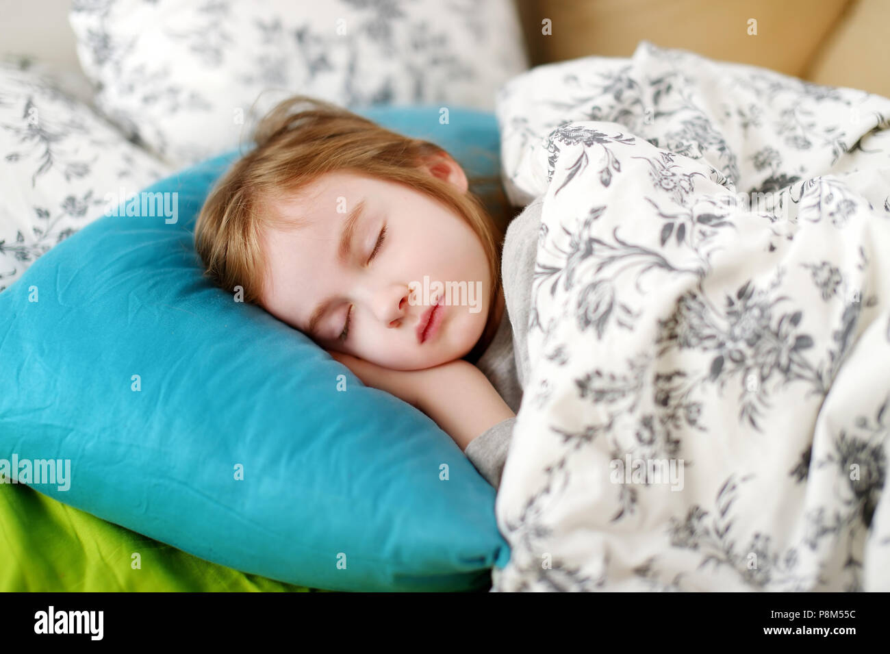 Adorable little girl sleeping in a bed Stock Photo - Alamy