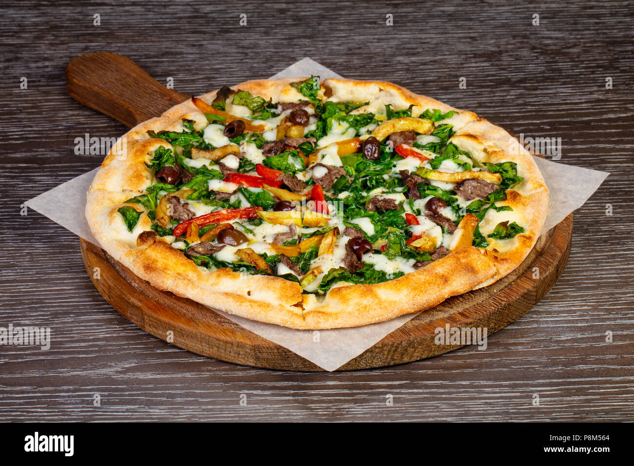 Delicious vegetarien 'Spinach' pizza with olives Stock Photo