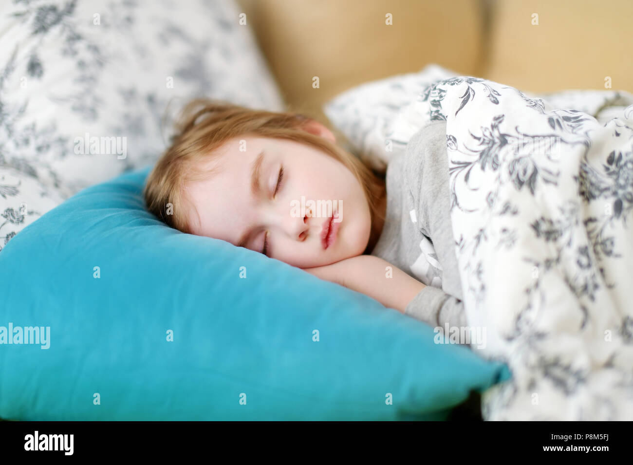 Adorable little girl sleeping in a bed Stock Photo - Alamy